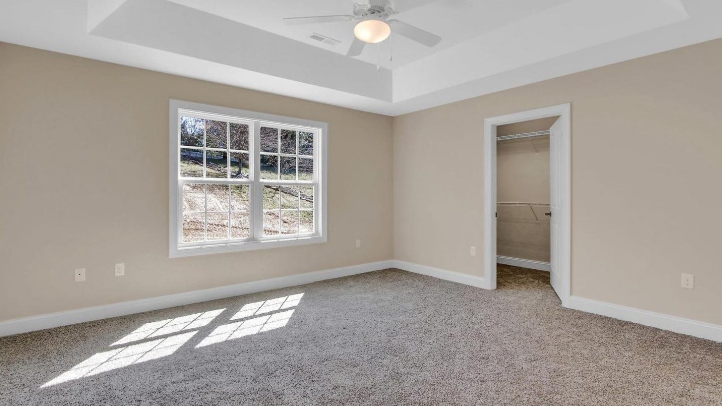 master bedroom with tray ceiling